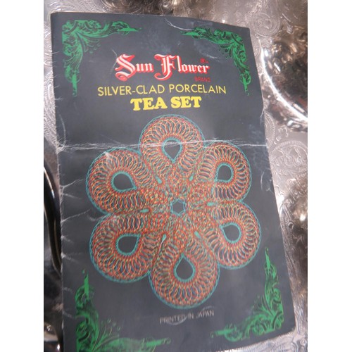 93 - SILVER CLAD PORCELAIN SUN FLOWER BRAND JAPANESE TEAPOT, SUGAR BOWL & MILK JUG WITH A SILVER PLATED S... 