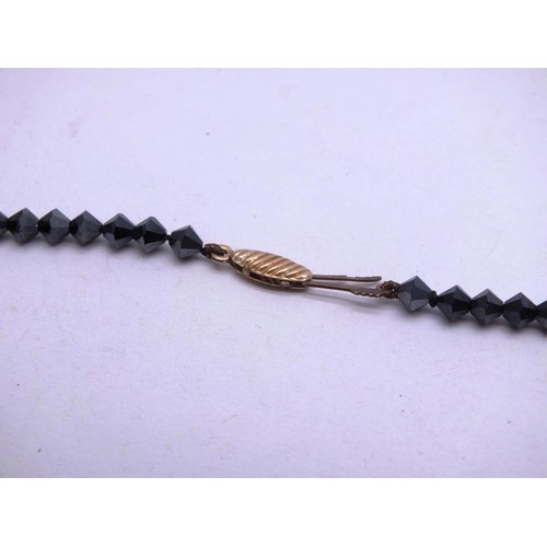 295 - ART DECO BLACK JET HAND FACETED BEAD NECKLACE WITH 9CT GOLD CLASP AND SPACER BEADS