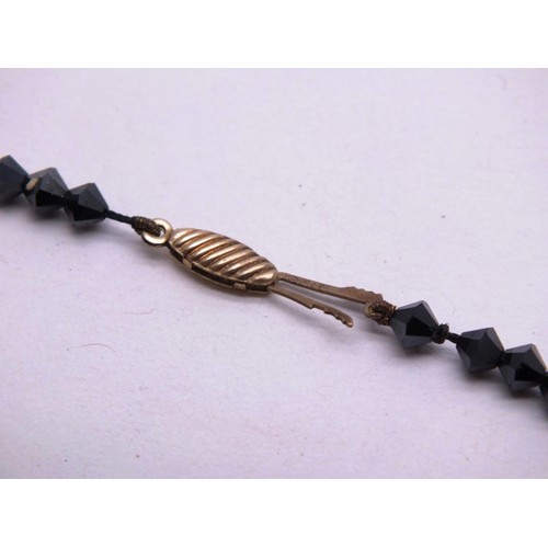 295 - ART DECO BLACK JET HAND FACETED BEAD NECKLACE WITH 9CT GOLD CLASP AND SPACER BEADS