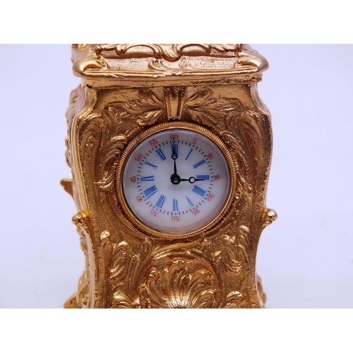 342 - ORNATE GOLD GILT MINIATURE CARRIAGE CLOCK WITH KEY- WORKING - HEIGHT 10CM