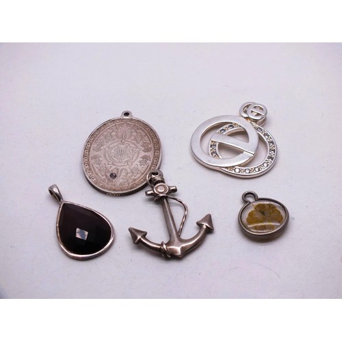 298 - FIVE SILVER PENDANTS INCLUDES SHIPS ANCHOR AND FOUR LEAF CLOVER