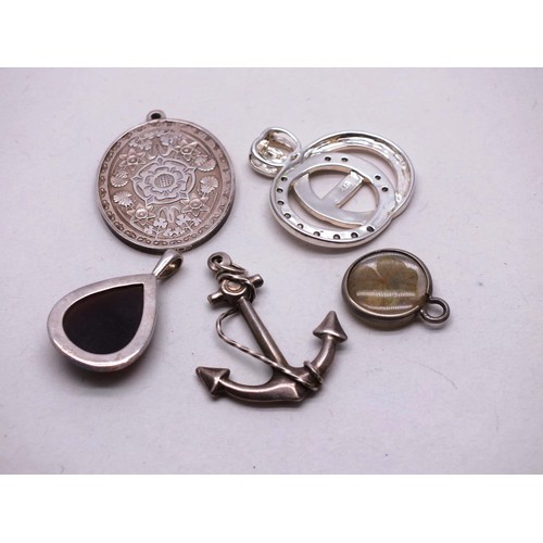 298 - FIVE SILVER PENDANTS INCLUDES SHIPS ANCHOR AND FOUR LEAF CLOVER