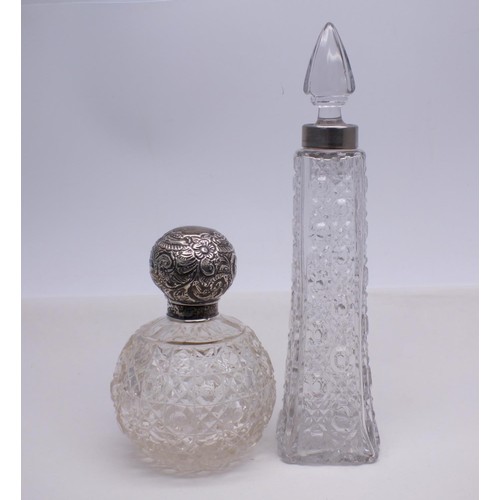 28 - TWO CUT GLASS BOTTLES ONE WITH SILVER TOP