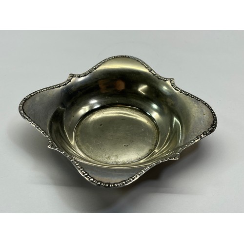 59 - SILVER RIMMED GLASS DISH - MARKED STERLING WITH ORIGINAL WHITE METAL BASE