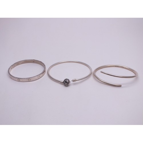 54 - THREE SILVER BANGLES