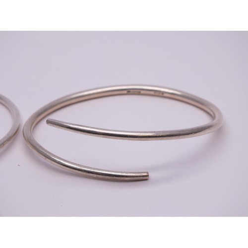 54 - THREE SILVER BANGLES