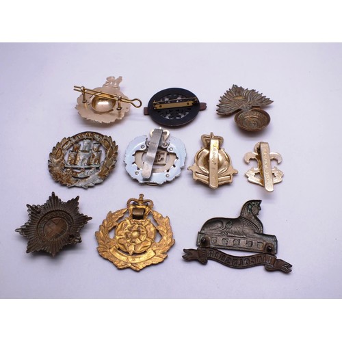 87 - TEN MILITARY CAP BADGES