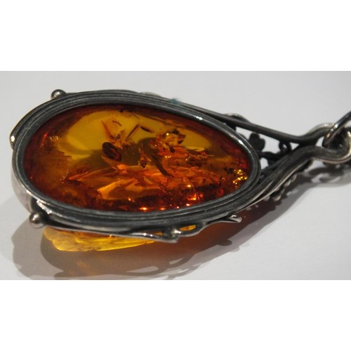 276 - TWO AMBER AND SILVER PENDANTS AND AMBER AND SILVER EARRINGS