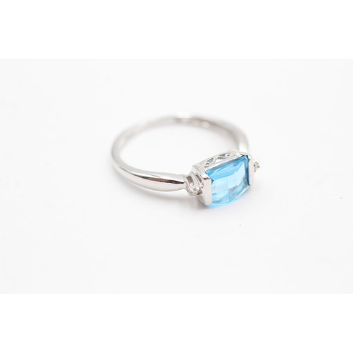 406 - 9ct white gold blue topaz & diamond three stone dress ring (2g) SIZE- O