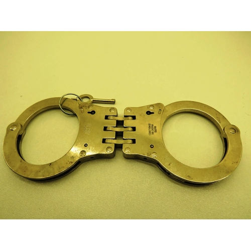 78 - REPLICA STICK GERNADE HANDCUFFS IN BLACK  LEATHER HOLDER, TOY PISTOL