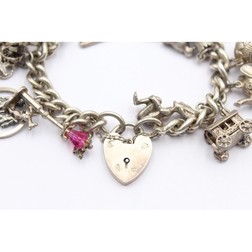 438 - .925 vintage charm bracelet with assorted charms (85g)