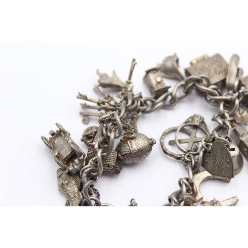 458 - .925 charm bracelet with assorted charms (71g)