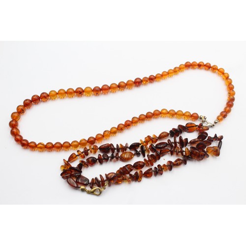 606 - 2 x amber necklaces (29g)