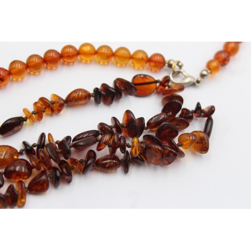 606 - 2 x amber necklaces (29g)