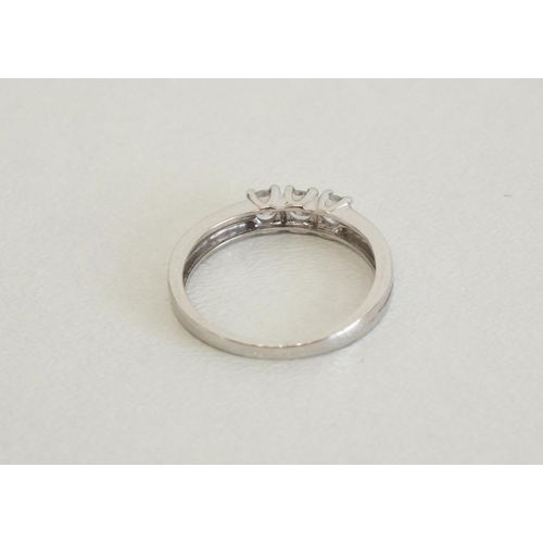 202 - 9CT WHITE GOLD RING WITH THREE CZ STONES - SIZE K, 1.4g