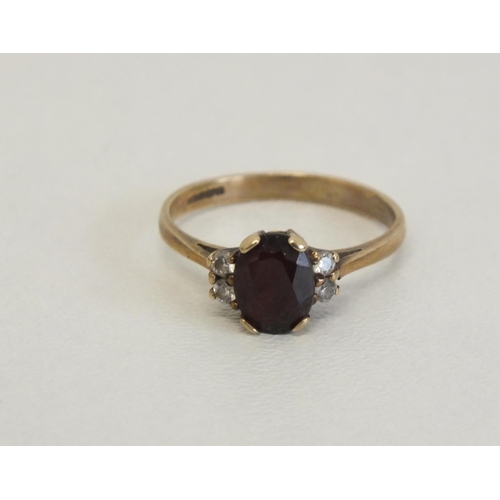 231 - 9CT GOLD RING WITH RED STONE AND FOUR CZ STONES - SIZEP, 2.2G