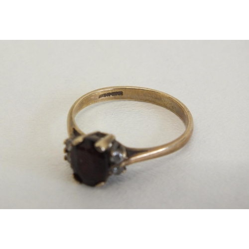 231 - 9CT GOLD RING WITH RED STONE AND FOUR CZ STONES - SIZEP, 2.2G