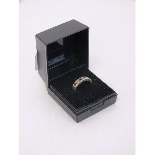 303 - LADIES 9CT GOLD SEVEN STONE RING