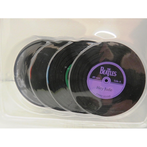 326 - THE BEATLES TIN WITH 224 PAGE BOOK AND FOUR VINYL RECORD COASTERS