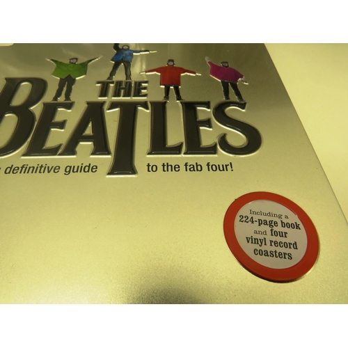 326 - THE BEATLES TIN WITH 224 PAGE BOOK AND FOUR VINYL RECORD COASTERS