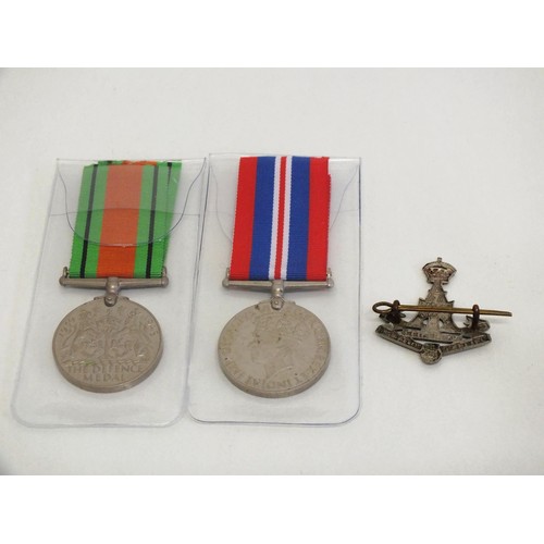 61 - TWO WW2 MEDALS AND YORKSHIRE REGIMENT BADGE