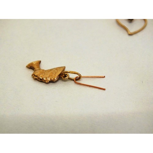 82 - FOUR 9ct GOLD CHARMS- 1.24g