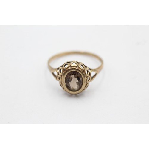 596 - 9ct gold smoky quartz solitaire ring with openwork frame (1.7g) - size P