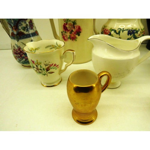 323 - NINE VINTAGE JUGS INCLUDES CROWN, WEDGEWOOD etc