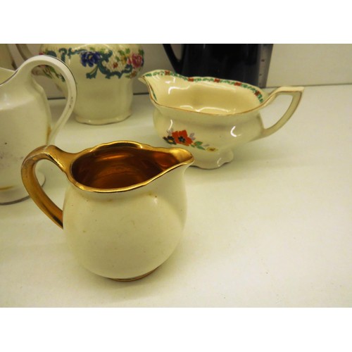 323 - NINE VINTAGE JUGS INCLUDES CROWN, WEDGEWOOD etc