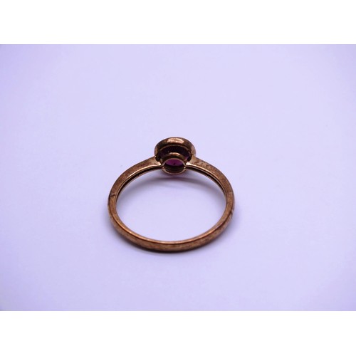 28 - 9ct GOLD BEZEL SET RED STONE SOLITAIRE RING- SIZE P, 1.65g