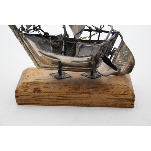 439 - Unmarked SILVER Ship Ornament with Wooden Stand (44g)