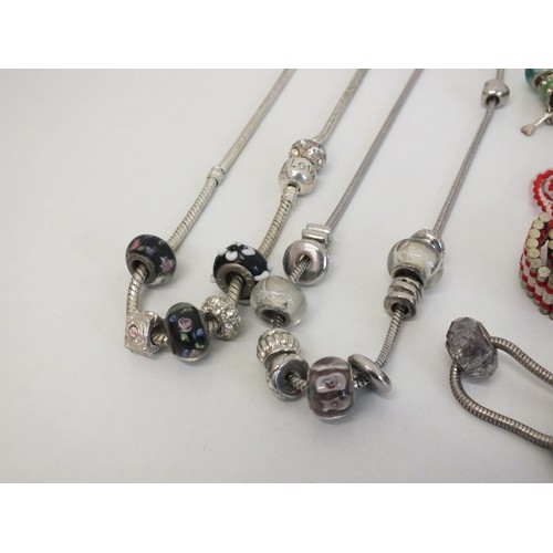 242 - 20 ASSORTED FASHION CHARM BRACELETS & NECKLACES