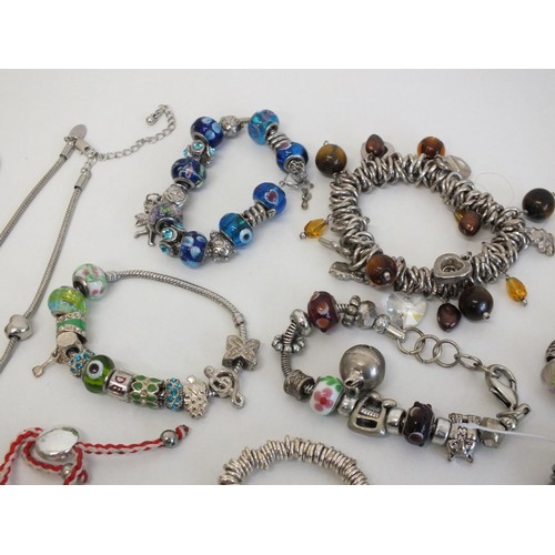 242 - 20 ASSORTED FASHION CHARM BRACELETS & NECKLACES