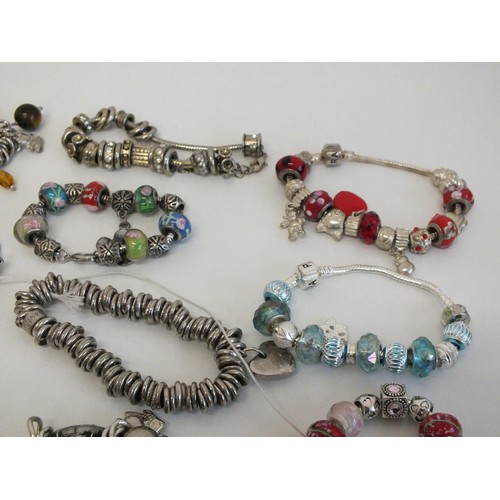 242 - 20 ASSORTED FASHION CHARM BRACELETS & NECKLACES