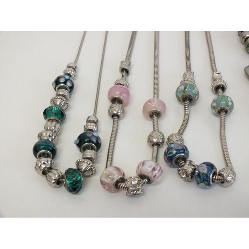 243 - 20 ASSORTED FASHION CHARM BRACELETS & NECKLACES