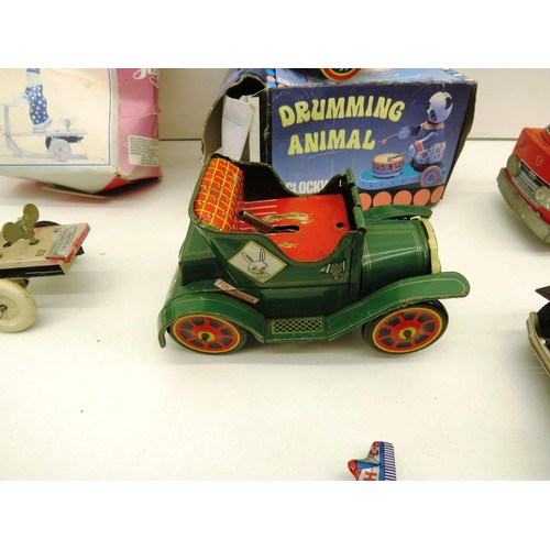 294 - SIX VINTAGE TIN TOYS INCLUDES BATTERY OPERATED AND WIND UP