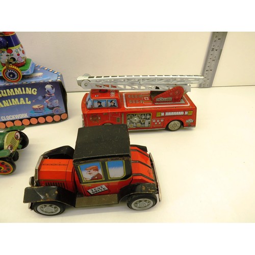 294 - SIX VINTAGE TIN TOYS INCLUDES BATTERY OPERATED AND WIND UP