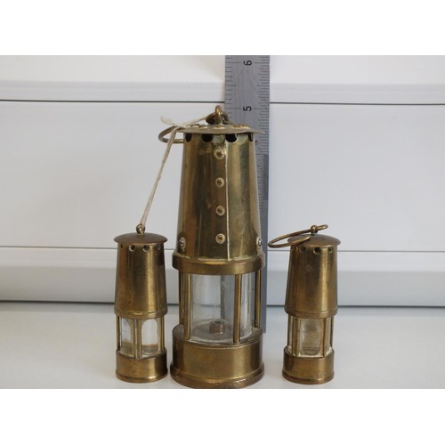 264 - THREE SMALL ORNAMENTAL BRASS MINERS LAMPS