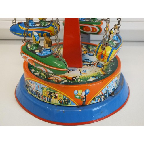 272 - PLANET ROCKET GO ROUND LEVER WIND TIN PLATE FAIRGROUND TOY