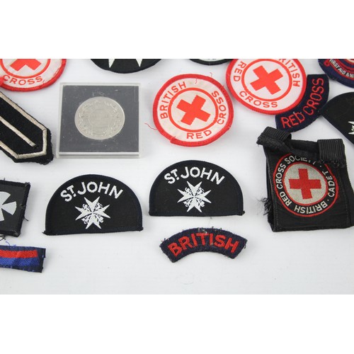 403 - Job Lot of British Red Cross, St John Ambulance Badges Inc Cloth & Metal, Etc