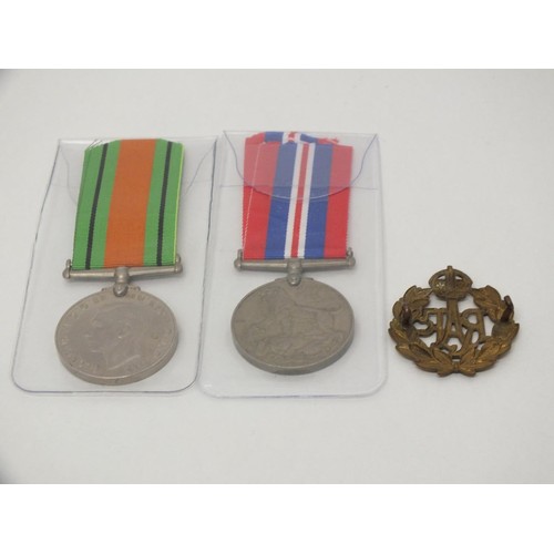 48 - TWO WWII MEDALS AND BRASS CAP BADGE