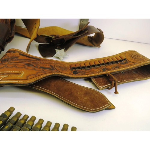 64 - TWO BROWN LEATHER GUN BELTS AND SHELL CASINGS BELT