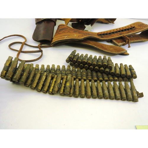 64 - TWO BROWN LEATHER GUN BELTS AND SHELL CASINGS BELT