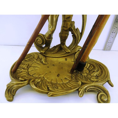 207 - ORNATE BRASS WALKING STICK STAND AND THREE WALKING STICKS/CANES