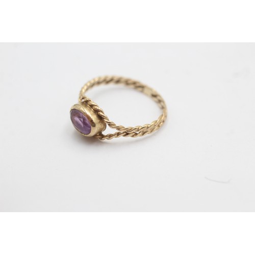 520 - 9ct gold twisted rope band oval amethyst solitaire ring (1.5g) SIZE- N