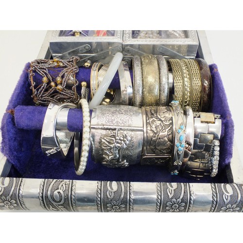 104 - LARGE SILVER COLOUR JEWELLERY BOX CRAMMED WITH BROOCHES, CLIP ON EARRINGS, BANGLES AND NECKLACES