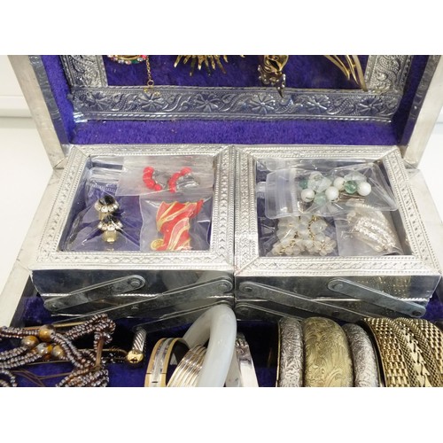 104 - LARGE SILVER COLOUR JEWELLERY BOX CRAMMED WITH BROOCHES, CLIP ON EARRINGS, BANGLES AND NECKLACES