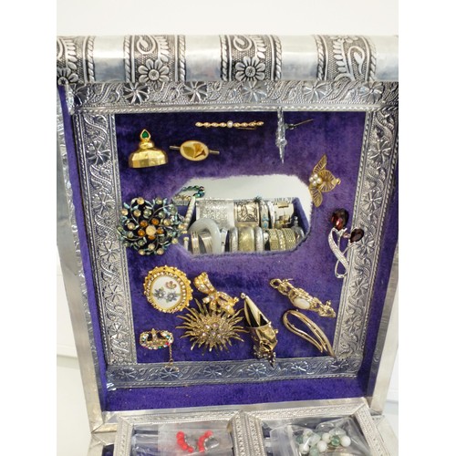 104 - LARGE SILVER COLOUR JEWELLERY BOX CRAMMED WITH BROOCHES, CLIP ON EARRINGS, BANGLES AND NECKLACES