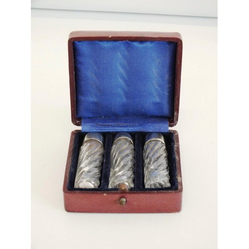 4 - SET OF THREE GLASS SCENT BOTTLES WITH SILVERPLATE TOPS IN A RED LEATHER BOUND PRESENTATION BOX & SET... 