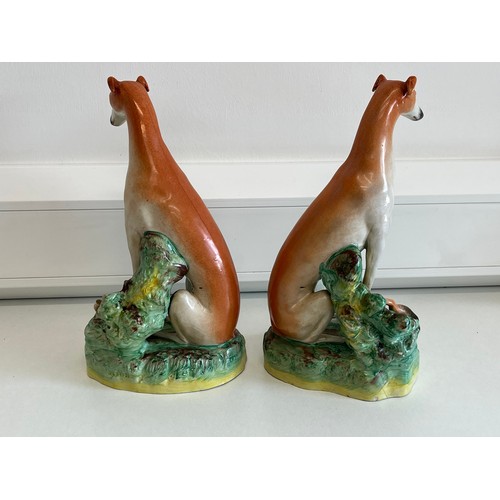 45 - PAIR OF 19th CENTURY STAFFORDSHIRE FIGURES OF GREYHOUNDS WITH HARES (ONE HAS DAMAGE TO HARES FOOT) 2... 